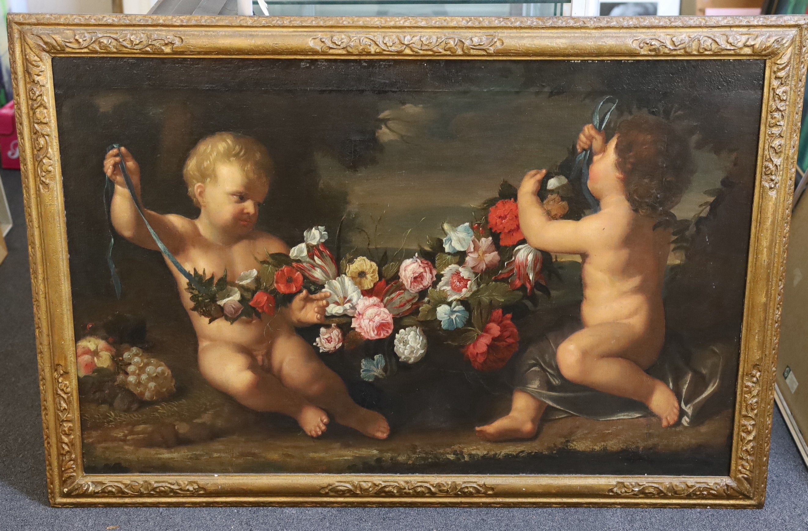 17th Century Roman School, Two putti holding a garland of flowers, oil on canvas, 76 x 118cm.